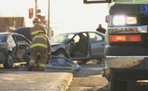 Firefighters helping victims of an auto accident