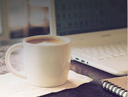 coffee and laptop on desk