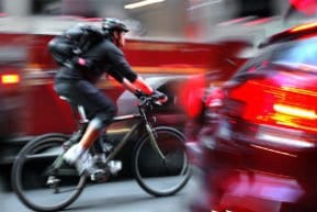 man riding bicycle through new jersey traffic