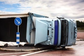 A tractor trailer truck on its side after a New Jersey truck accident prompts attorneys to determine who is liable.