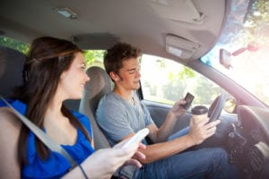 Teenage boy driving while distracted