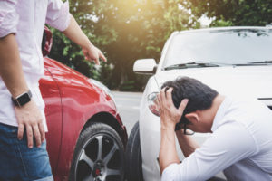 Two men on the street talking after an auto accident
