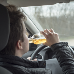 a man in NY driving his car while drinking