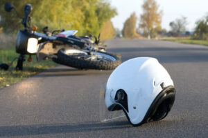 Helmet and motorcycle on the road after an accident