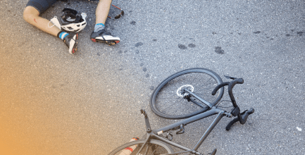 person laying on the ground, hurt from a bicycle accident in New Jersey