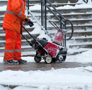 person clearing snow and ice on public property in pennignton