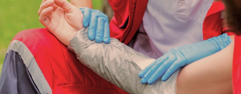 Image of an arm injury being aided