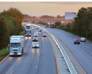 trucks and car on a highway