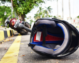 a crashed motorcycle with the helmet on the street