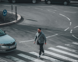 a man crossing a pedestrian lane