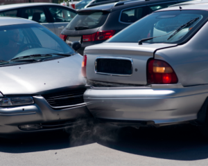 a car crashed into another car while getting out of a parking lot