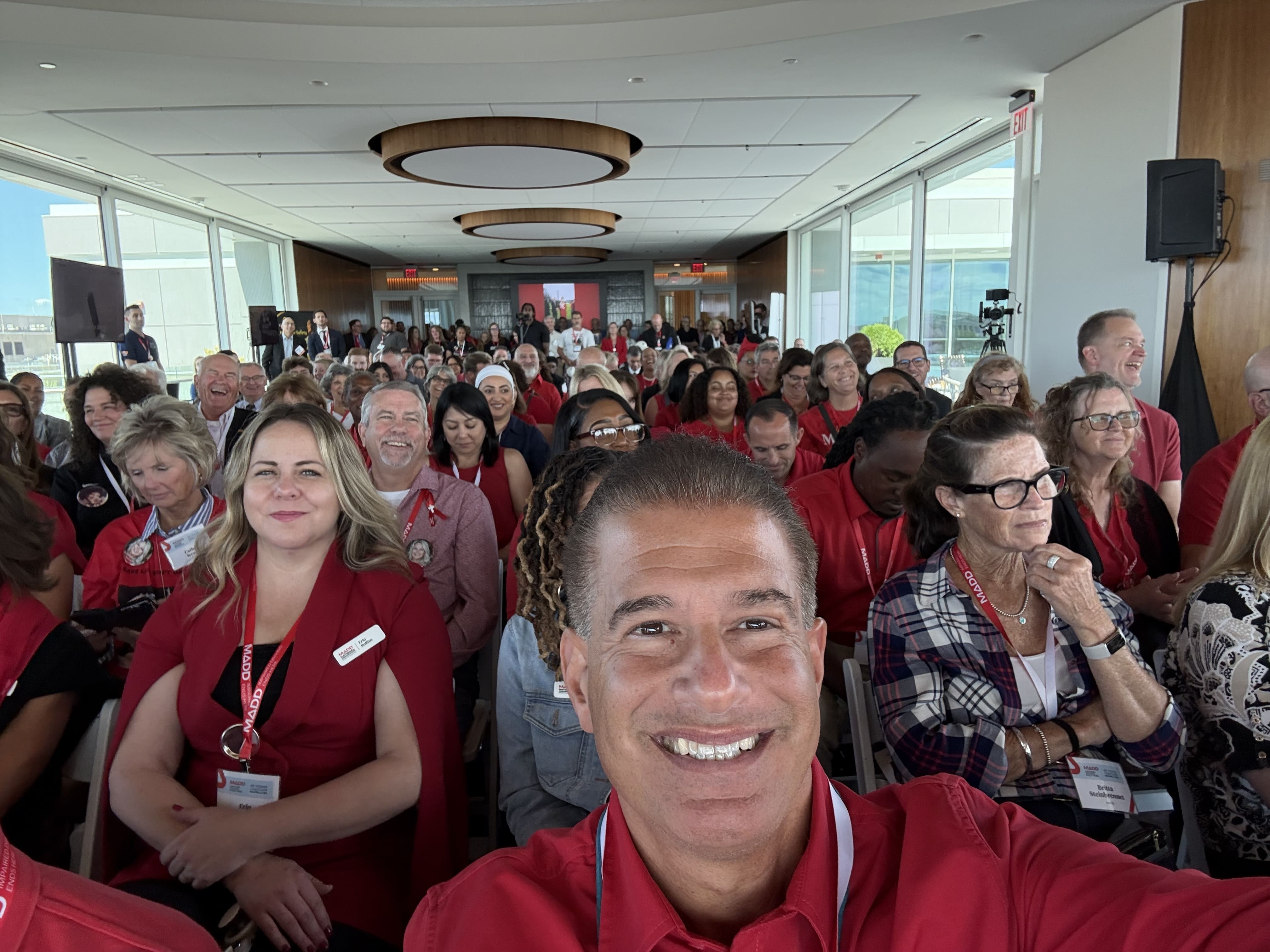 Steven Benvenisti selfie with multiple people in a room